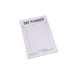 Quill A4 day planner pad, white sheet printed with a Day Planner heading and ruled time slots, shown at an angle