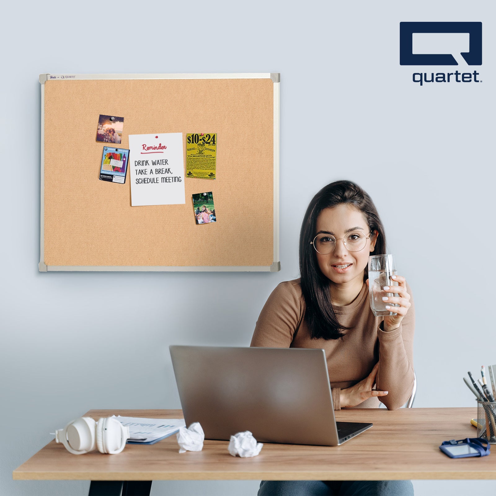 Lifestyle image showing the Quartet Corkboard Aluminium Frame 900 x 600mm in a home office where reminders, photos and important notices are displayed above a workstation. The corkboard helps organise daily tasks while complementing a clean and productive workspace.