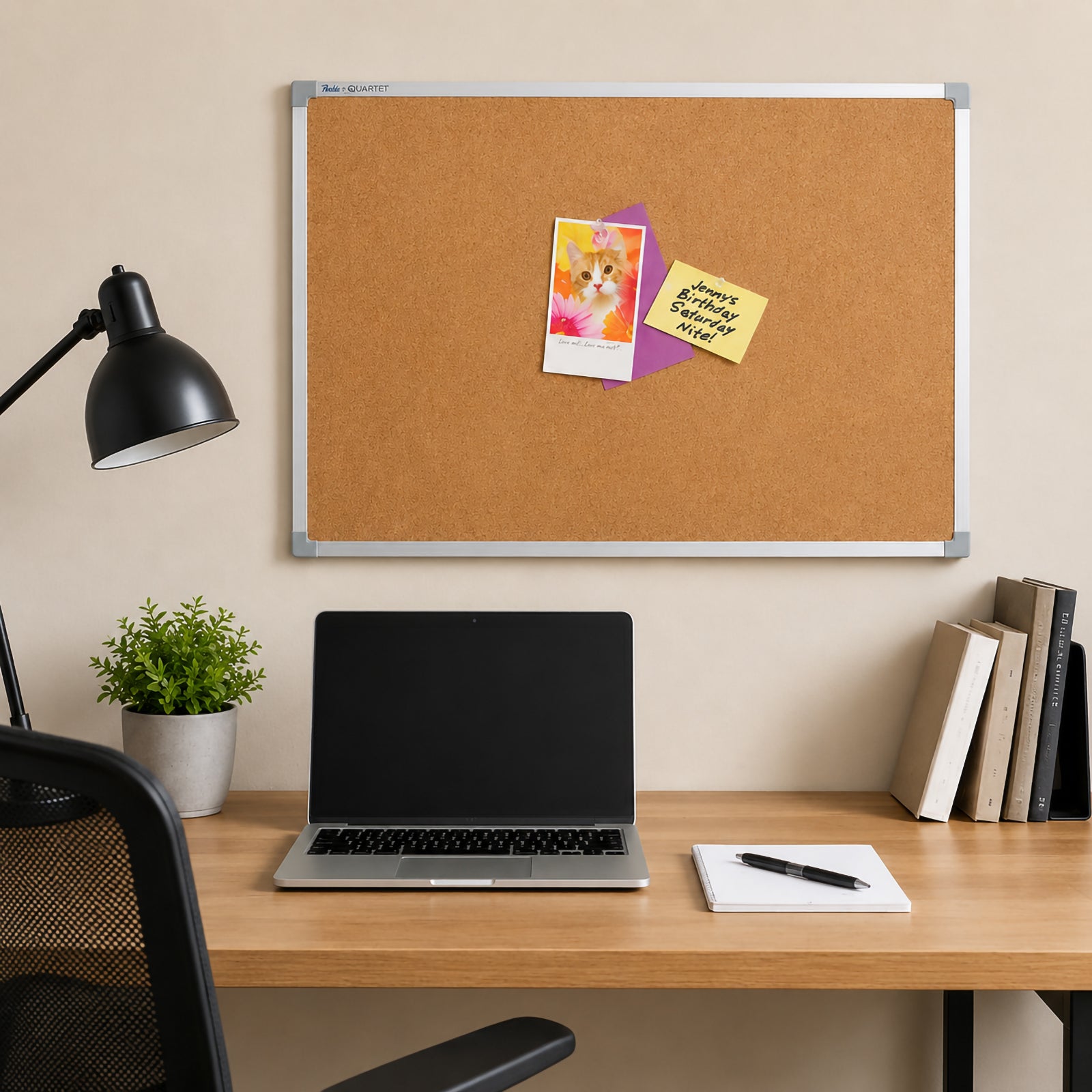 Quartet Corkboard Aluminium Frame 900 x 600mm mounted above a modern office desk displaying photographs, notes and reminders. The self healing cork surface and stylish aluminium frame complement a contemporary workspace while providing an organised area for everyday communication.