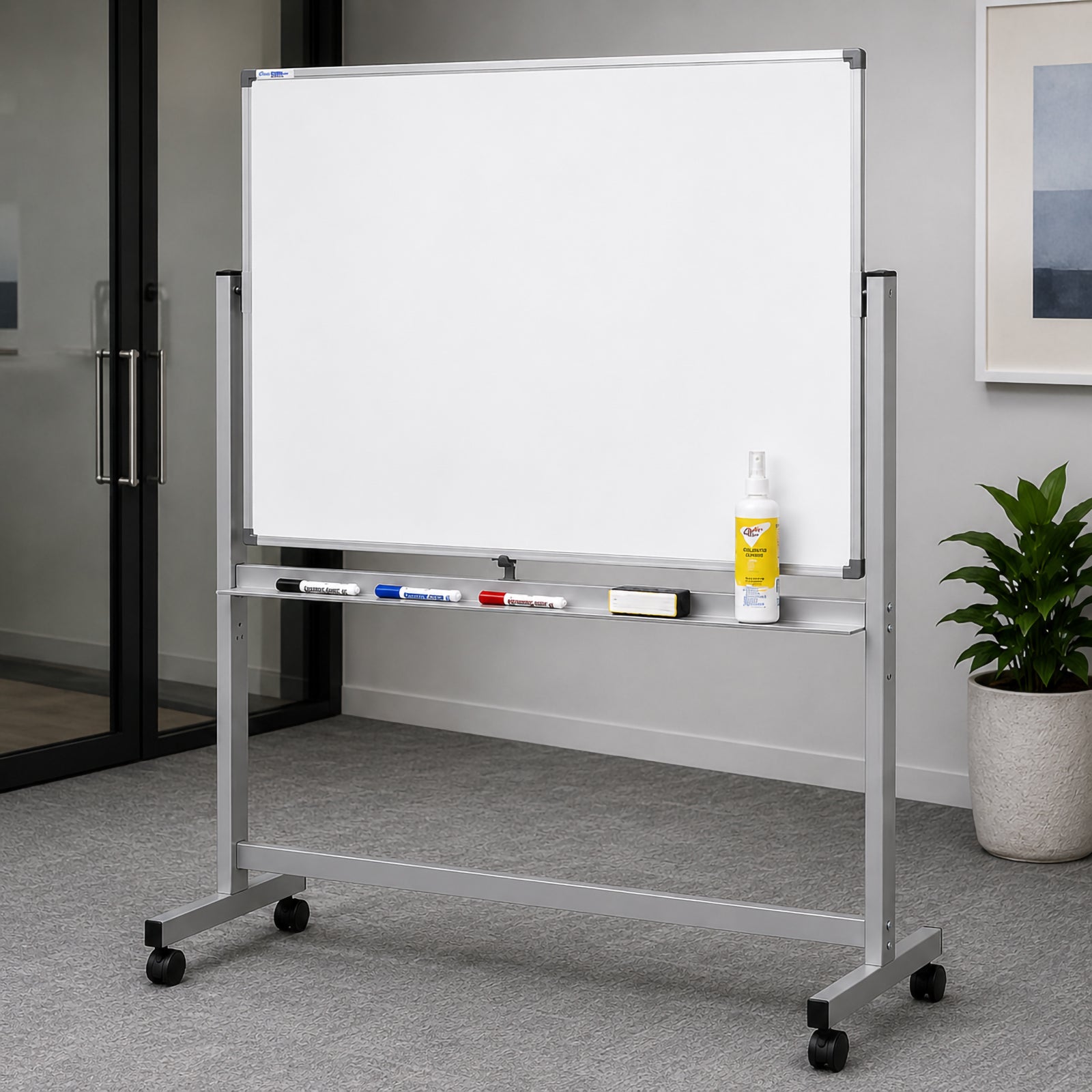 The Quartet Penrite Magnetic Porcelain Mobile Whiteboard 1200 x 900mm positioned in a contemporary office setting with a clean blank writing surface ready for presentations and brainstorming. The robust aluminium frame, integrated marker tray and lockable castors emphasise its mobility, durability and professional appearance.