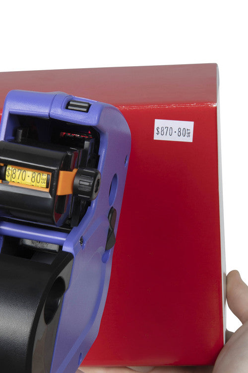 QuikStik Mark I Price Gun shown alongside included white permanent label rolls and bonus rolls, ready to use straight out of the box for immediate retail pricing