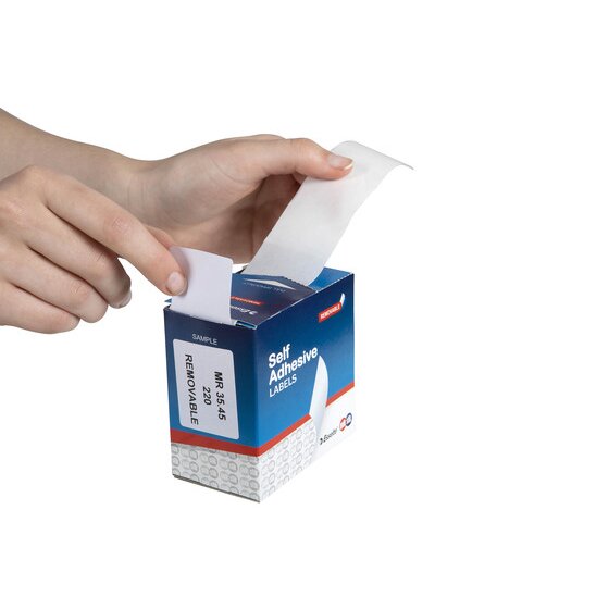 Hand drawing a white 35 x 45mm removable label from the top slot of a QuikStik dispenser box