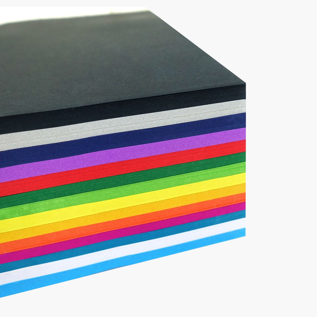 Corner view of a stack of Quill A4 assorted cover paper showing black, grey, navy, purple, red, green, yellow, orange, pink and sky blue layers