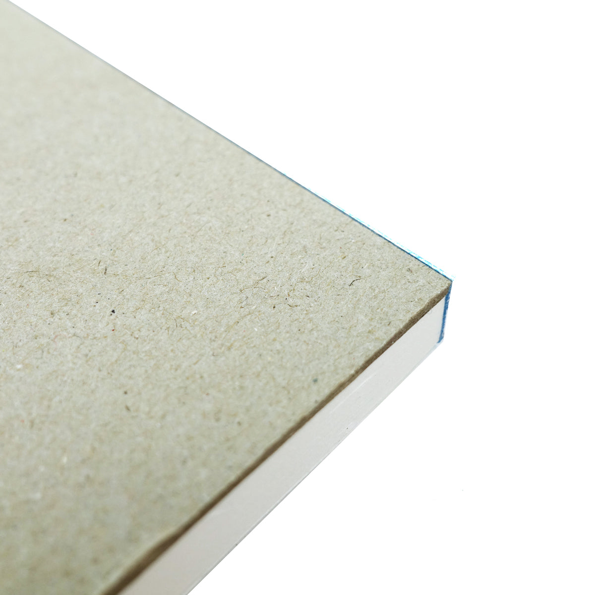 Underside corner of the Quill Sketch Pad A4 showing the grey heavyweight backing board with the white leaves above it