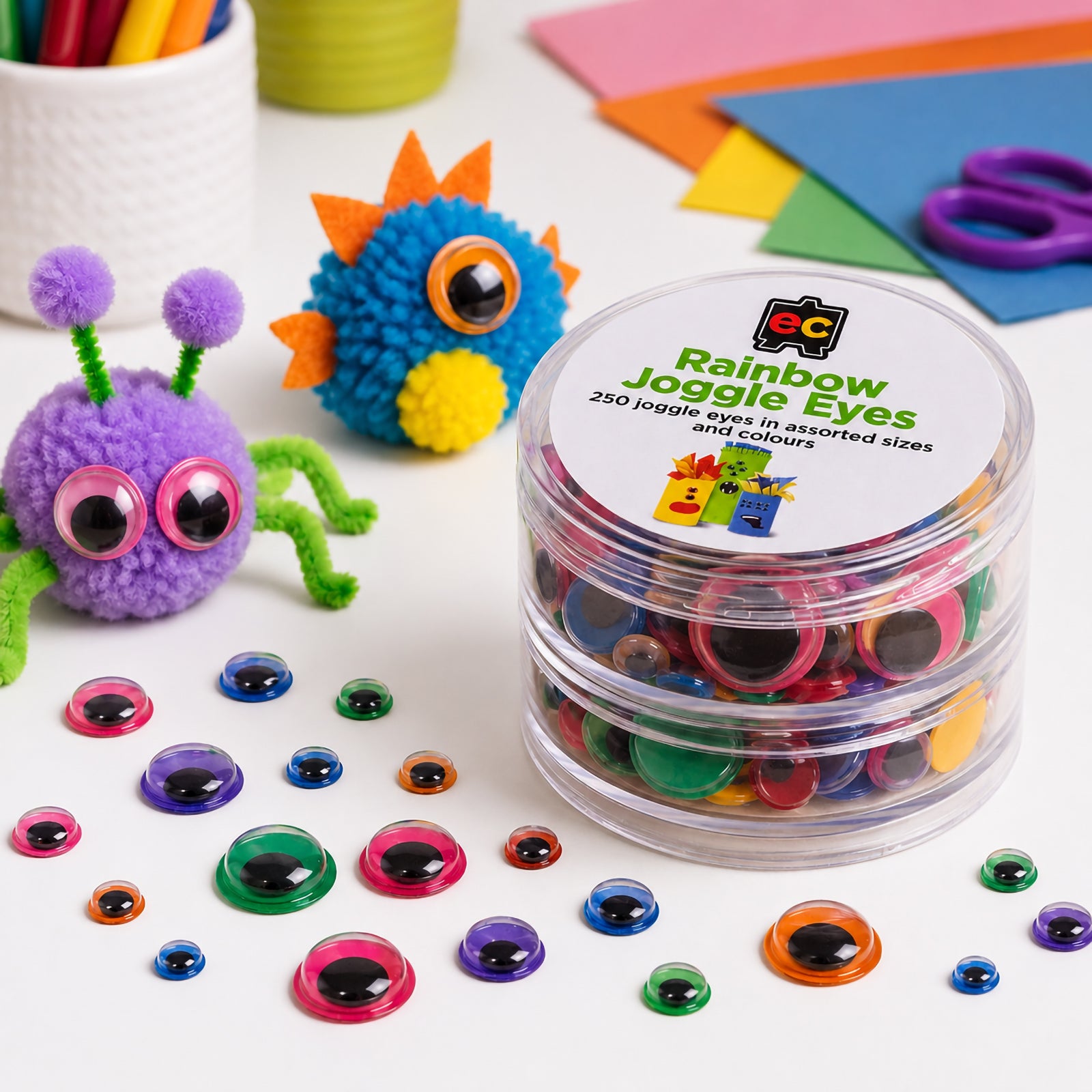 Rainbow joggle eyes displayed beside colourful pom pom creatures and craft materials. The assorted sizes and vibrant colours highlight the versatility of the set for creating imaginative characters, classroom projects and decorative art activities.