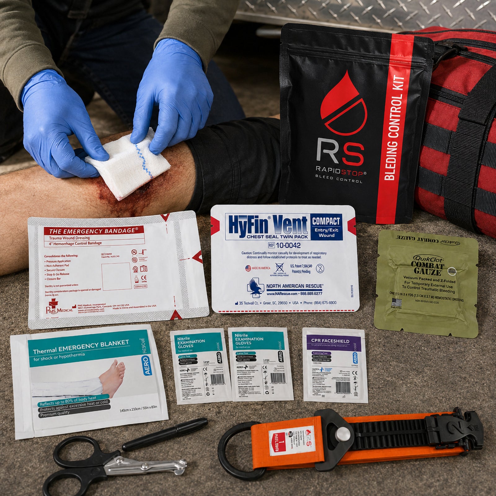 RapidStop Bleed Control Medium Pack displayed during a simulated emergency response with a gloved responder treating a leg injury. The black and red RapidStop pouch sits beside the QuikClot Combat Gauze, HyFin Vent Compact chest seal, emergency trauma bandage, thermal emergency blanket, nitrile gloves, CPR faceshield, trauma shears, marker and orange RapidStop tourniquet.
