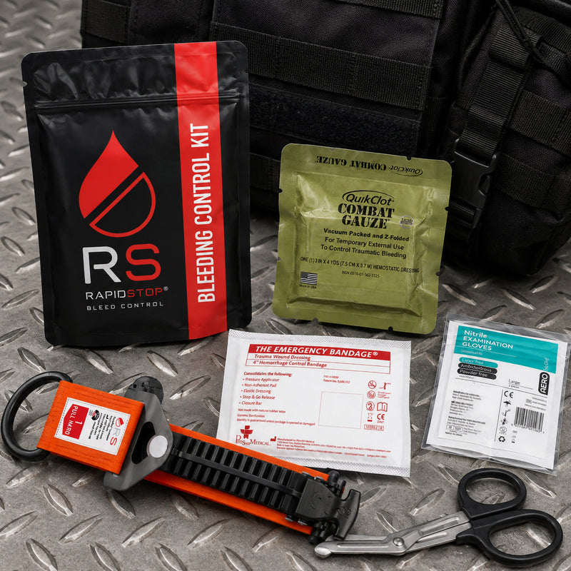 Compact RapidStop bleeding control equipment displayed on an industrial metal surface beside a tactical style bag. The image highlights the RapidStop pouch and QuikClot Combat Gauze together with the tourniquet, emergency compression bandage, nitrile examination gloves and trauma shears for portable emergency preparedness.
