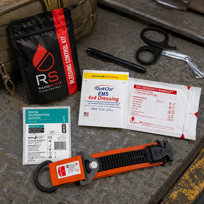 RapidStop emergency bleeding control equipment presented on an industrial metal surface beside a field bag. The QuikClot EMS 4x4 Dressing and emergency trauma bandage are positioned with nitrile gloves, trauma shears, marker, RapidStop tourniquet and compact black bleeding control pouch.