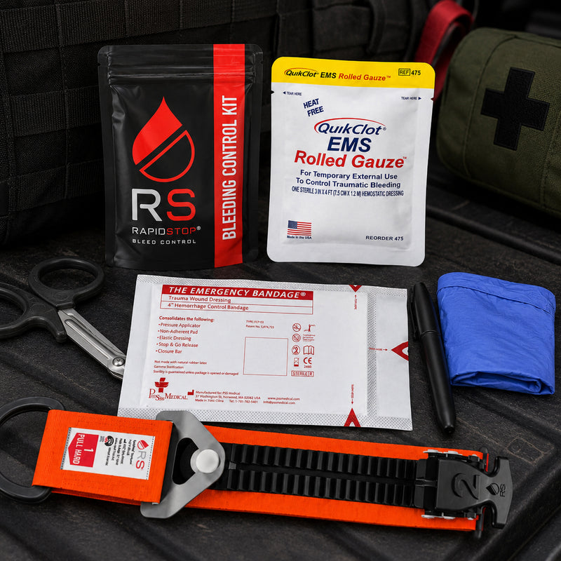 RapidStop emergency bleeding control components displayed on dark tactical equipment, including the orange RapidStop tourniquet, QuikClot EMS Rolled Gauze, packaged trauma wound dressing, trauma shears, black marker, blue examination gloves and RapidStop kit pouch.