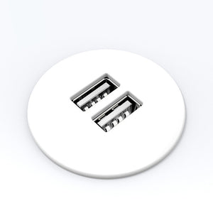 Round white two port USB charging module face seen from above