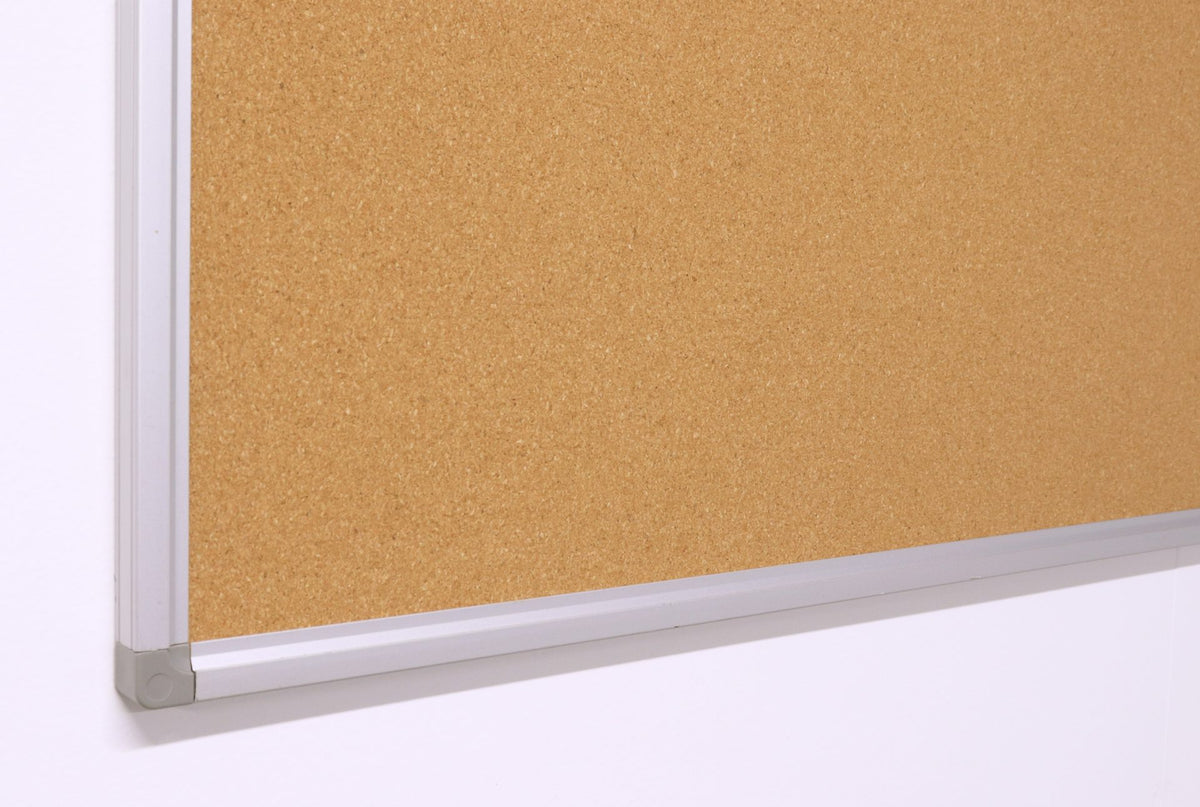 Close up of a lower corner of the Rapidline Standard Corkboard, showing the aluminium frame and its corner piece against the cork surface.