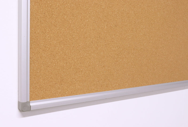 Close up of a lower corner of the Rapidline Standard Corkboard, showing the aluminium frame and its corner piece against the cork surface.
