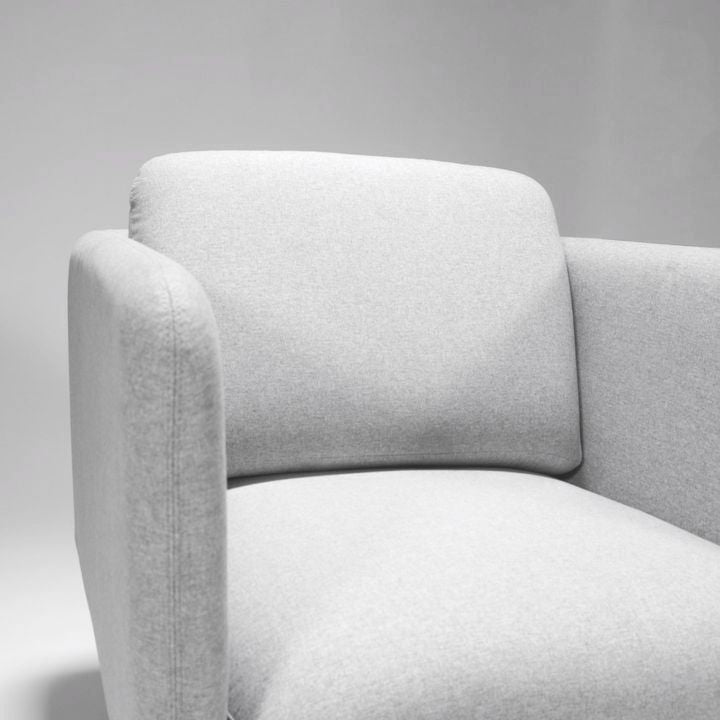 Close up of the Rapidline Capri one seater in light grey fabric, showing the arm, back cushion and seat upholstery.