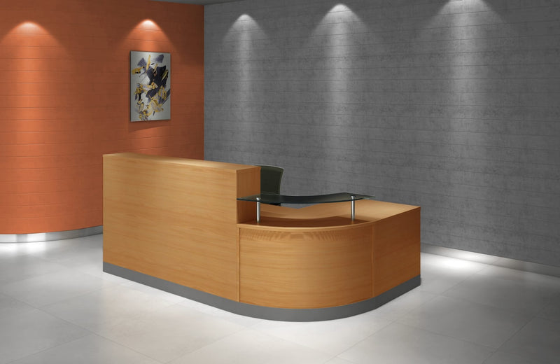 Rapidline Flow reception counter in beech set in a reception area with a grey feature wall, artwork and downlights, glass hob facing the room.