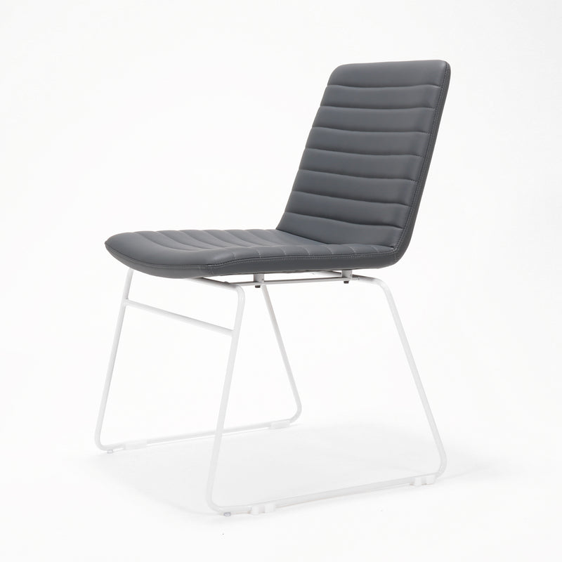 Rapidline Pixel sled base visitor chair in French Navy PU on a white powdercoated continuous sled base, product photograph on a plain background showing the ribbed horizontal stitching across the seat and back.