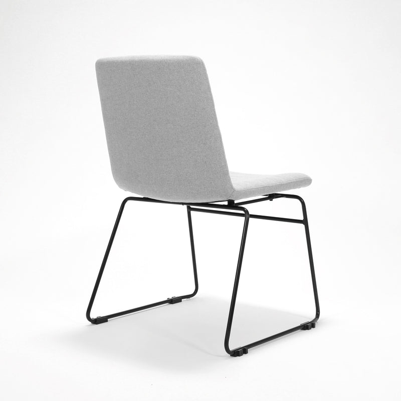 Rapidline Pixel sled base visitor chair in light grey commercial fabric on a black powdercoated continuous sled base, product photograph on a plain background showing the ribbed horizontal stitching across the seat and back.