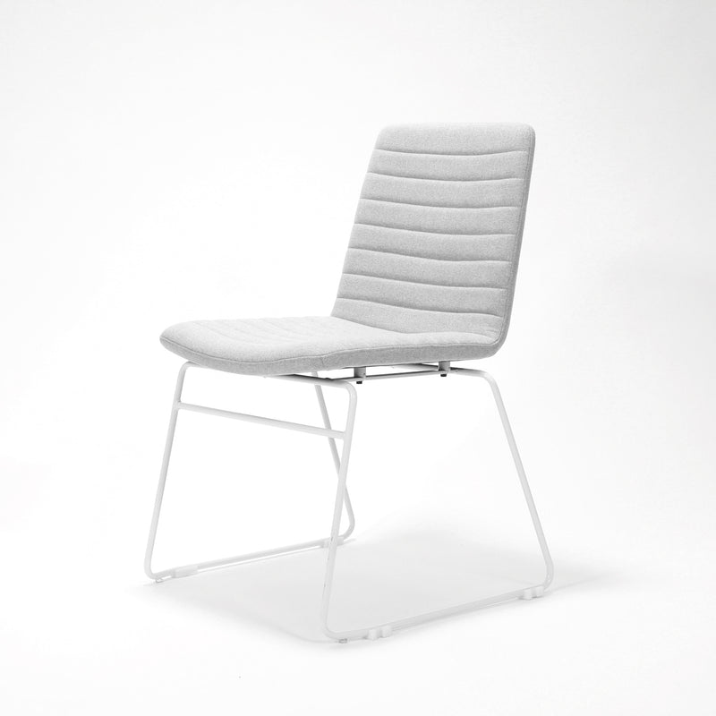 Rapidline Pixel sled base visitor chair in light grey commercial fabric on a white powdercoated continuous sled base, product photograph on a plain background showing the ribbed horizontal stitching across the seat and back.