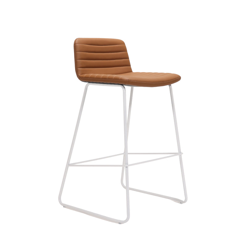 Rapidline Pixel bar high stool in amber PU on a white powdercoated tall sled base with a foot rail, product photograph on a plain background showing the ribbed horizontal stitching across the seat and back.