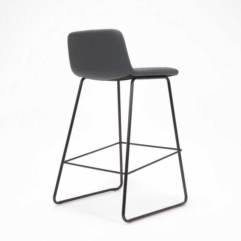 Rapidline Pixel bar high stool in French Navy PU on a black powdercoated tall sled base with a foot rail, product photograph on a plain background showing the ribbed horizontal stitching across the seat and back.