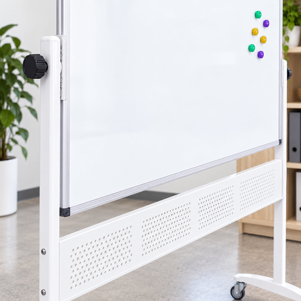 Close up view of the Rapidline mobile magnetic whiteboard showing the aluminium board frame, pivoting side mechanism, adjustment knob and sturdy mobile support structure. Coloured magnets are positioned on the clean white magnetic surface, highlighting the practical display capability and robust construction for regular office or classroom use.