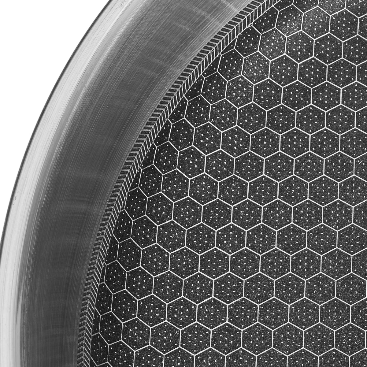 Macro close-up of the Resto Achird honeycomb surface, raised stainless steel cells with dark non-stick coating set into the recesses