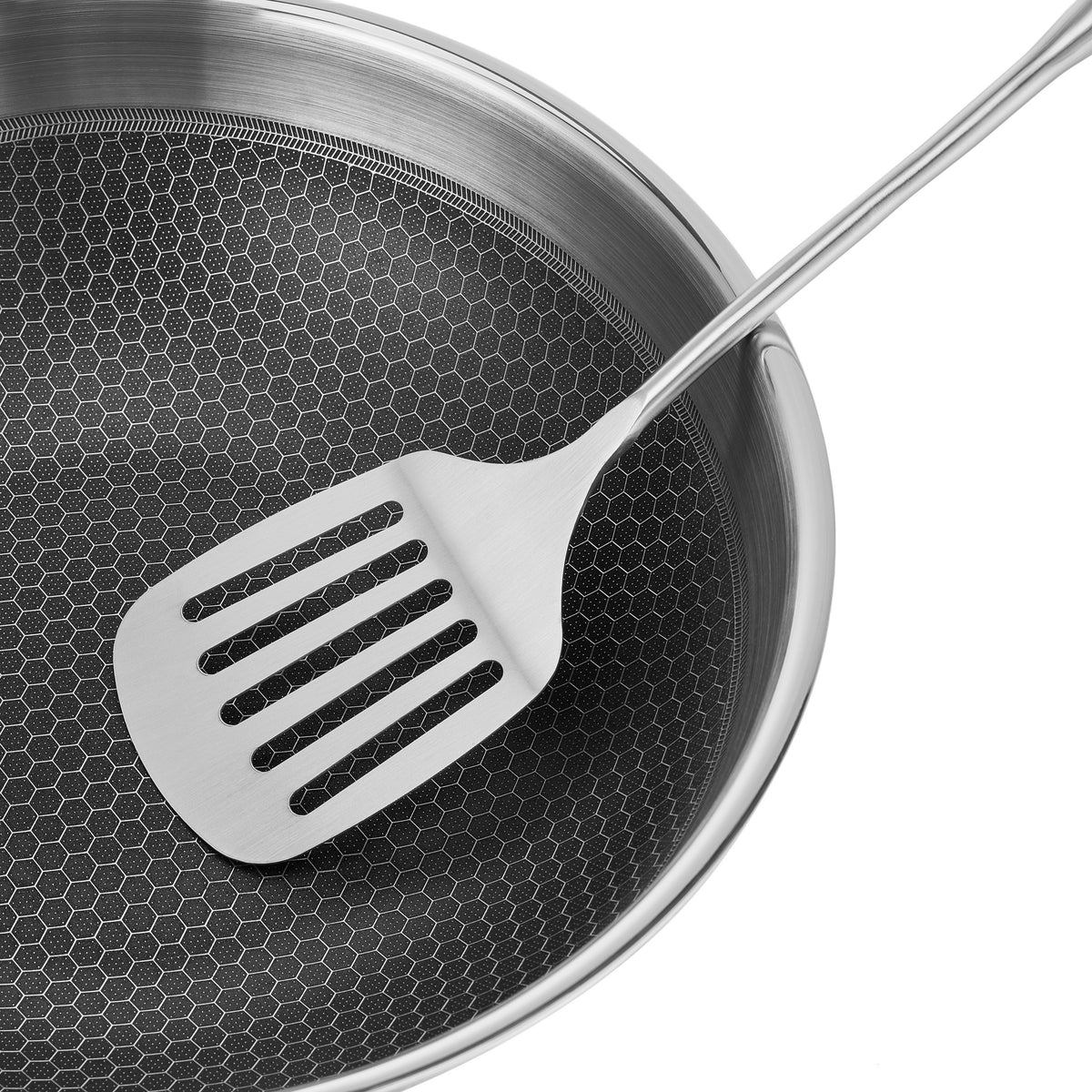 Resto Achird 28cm wok shown with a metal spatula resting on the honeycomb surface (spatula not included)