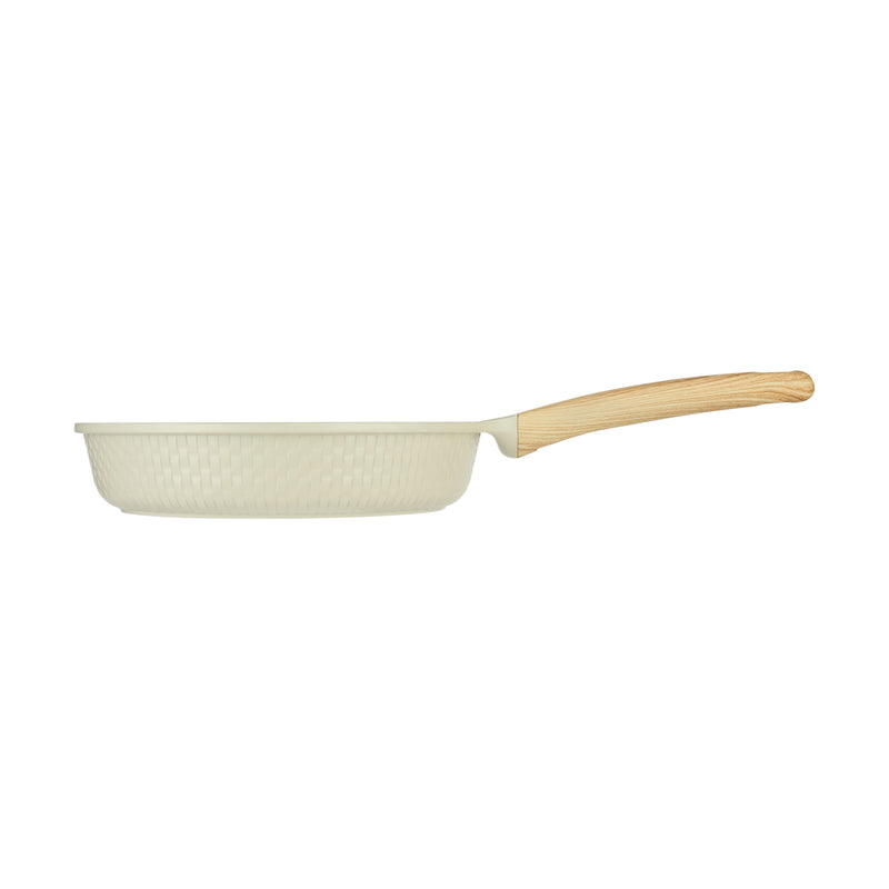 Side profile of the beige Resto Ran 24cm frypan showing its depth, the woven relief exterior and the angle of the soft-touch handle
