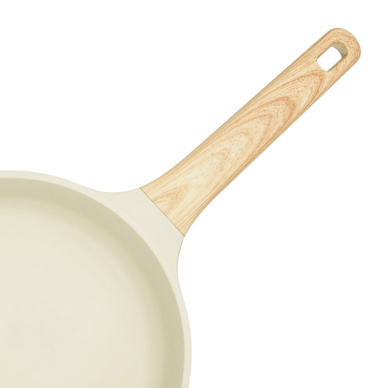 Close-up of the wood-grain-effect soft-touch handle on the beige Resto Ran frypan, with the hanging loop at the end