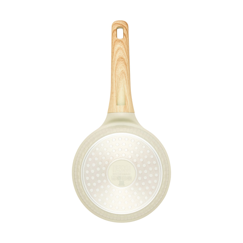 Underside of the beige Resto Ran 16cm saucepan showing the induction base plate
