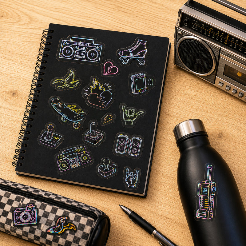 Sticker sheet displayed on a notebook surrounded by retro themed accessories including a cassette radio and stationery. The colourful glow designs showcase classic entertainment and gaming inspired icons.