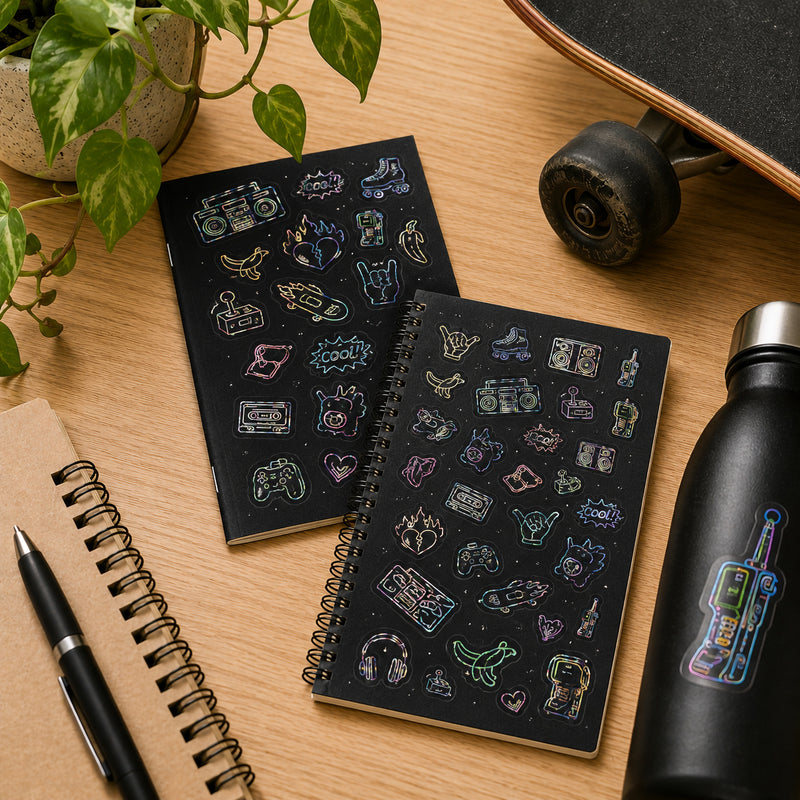 Retro Glow glow in the dark stickers decorating notebooks and a drink bottle beside a skateboard. Vintage inspired designs including boom boxes, gaming icons, roller skates and skateboards create a fun nostalgic aesthetic.
