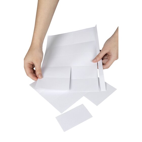 Hands tearing a white perforated insert card away from an A4 sheet of Rexel convention badge cards