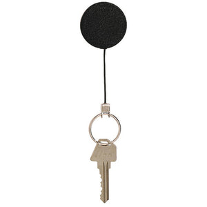 Rexel heavy duty retractable key holder front on, a matt black round reel with the nylon cord extended to a split ring holding one brass key, on a white background.