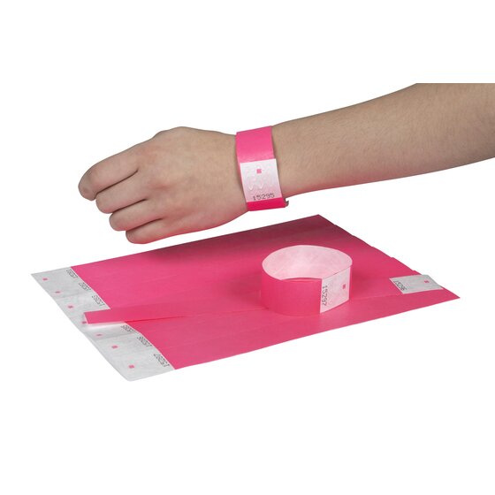 Fluoro pink Rexel wristband fastened on a wrist, with a numbered pink sheet and a closed band in front