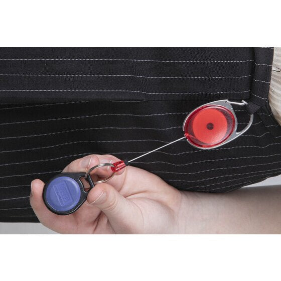 Rexel red snap lock key holder clipped to a dark pinstriped jacket, the cord pulled out to a hand holding a blue oval access fob.