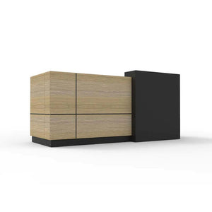 Rapidline Sempre reception counter in natural oak and black seen from the visitor side at an angle, natural oak panels beside a tall black stand off module.