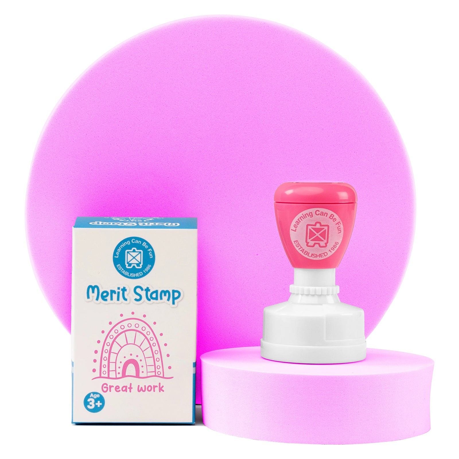 The stamp and retail packaging are displayed on a presentation stand against a soft pink backdrop. The image emphasises the product's vibrant appearance, quality construction and connection to the Sacred Country collection by Holly Sanders.
