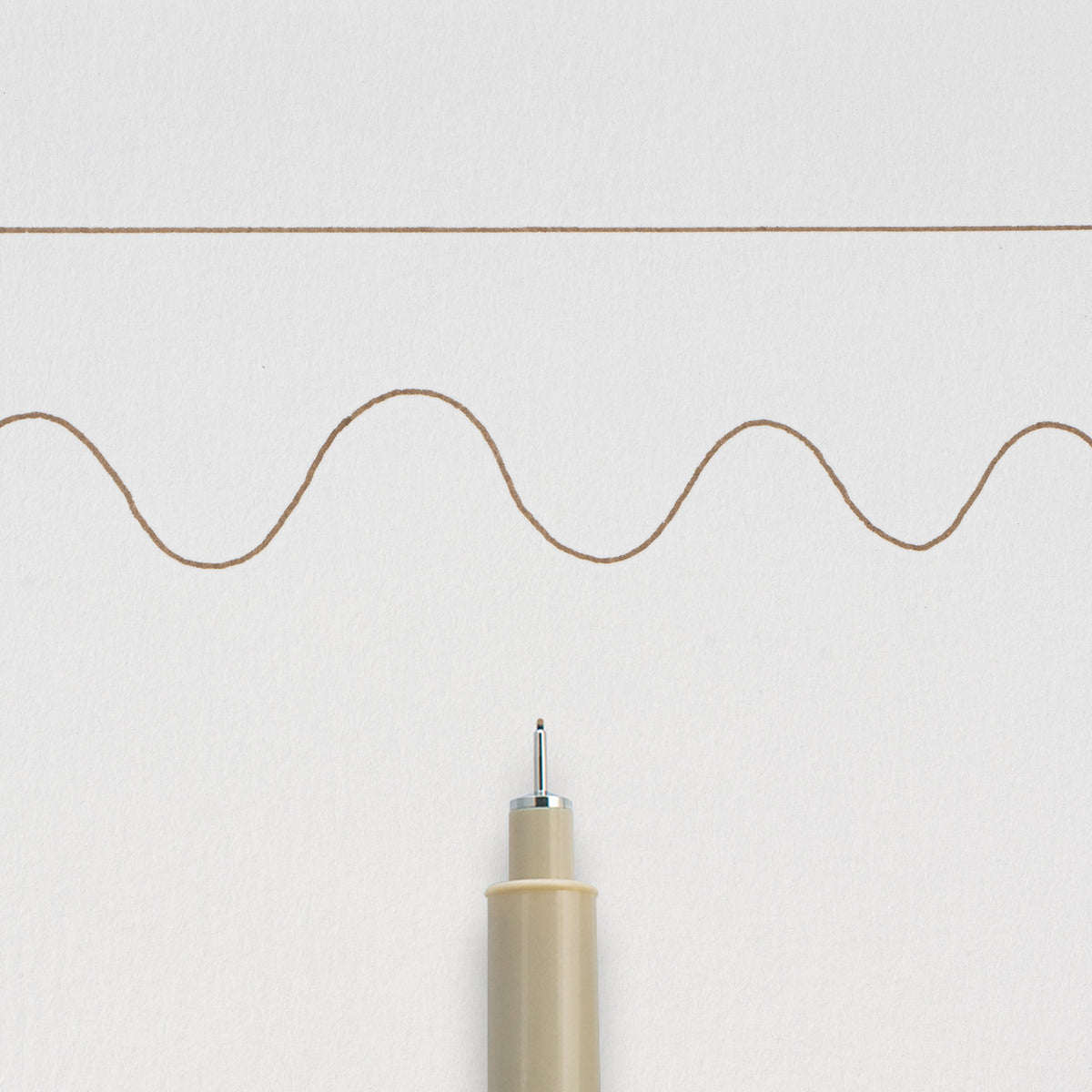 Sakura Pigma Micron 01 Sepia: needle tip below a straight and a wavy 0.25mm test line drawn on white paper