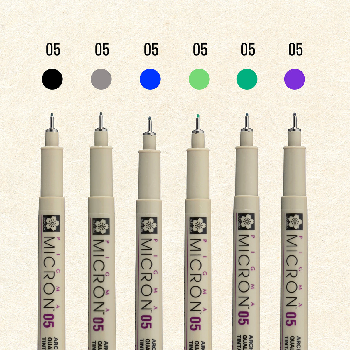 Sakura Pigma Mandala Cool Tone Set 05: six Micron 05 pens under black, grey, blue, light green, green and purple colour dots