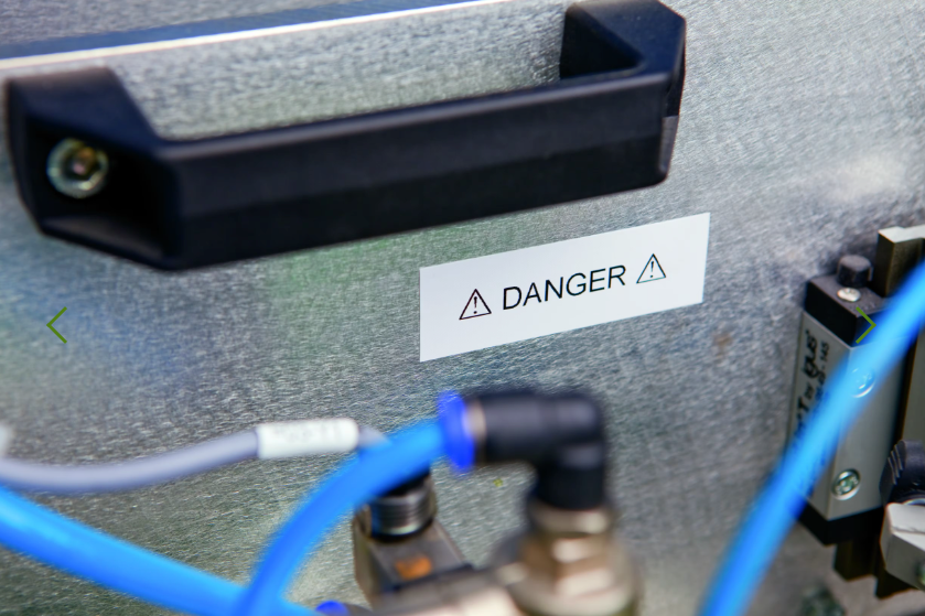 Electrical panel with wiring and a 'Danger' label