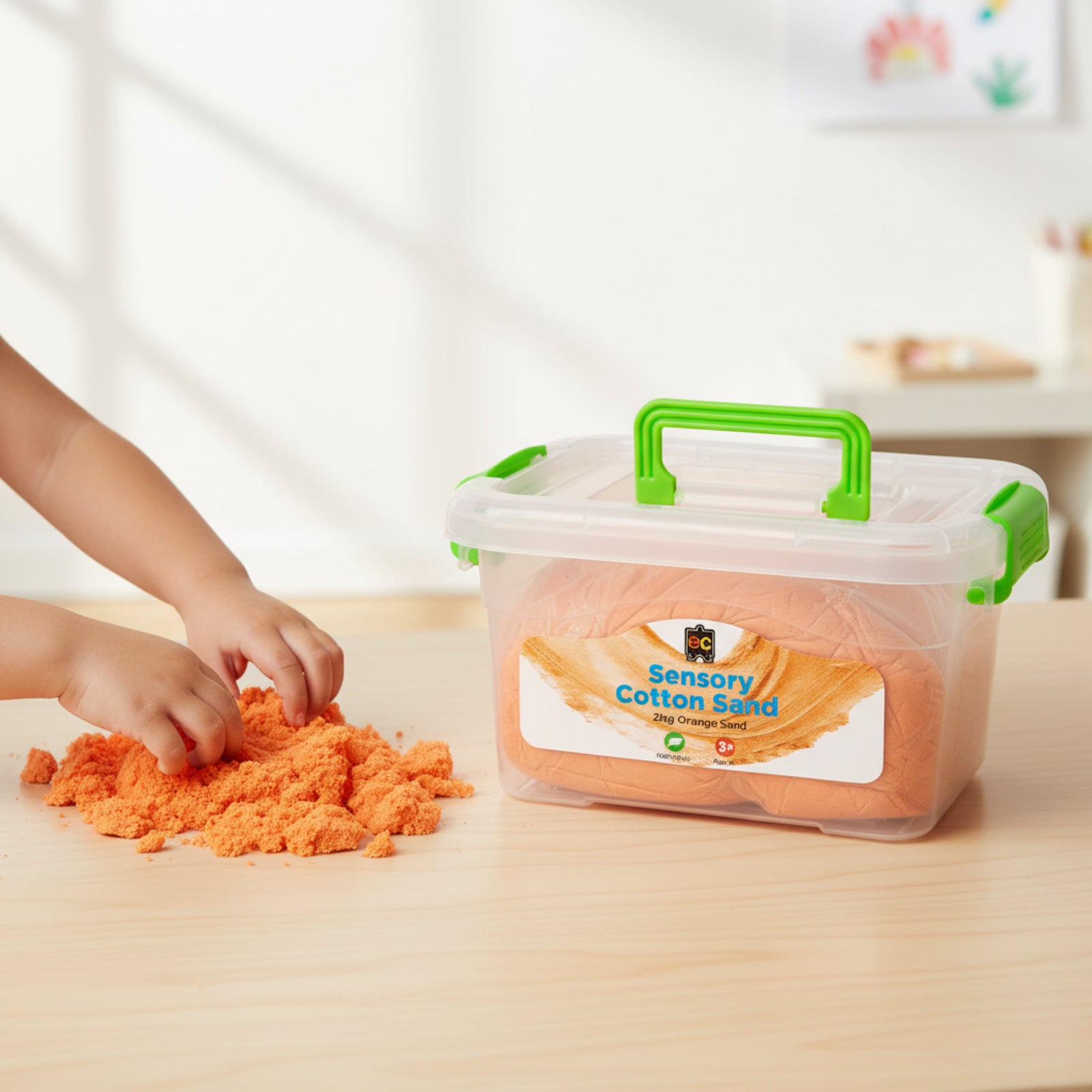 Child exploring bright orange Educational Colours Sensory Cotton Sand 2kg Orange beside reusable storage tub during tactile sensory play activity on classroom table.
