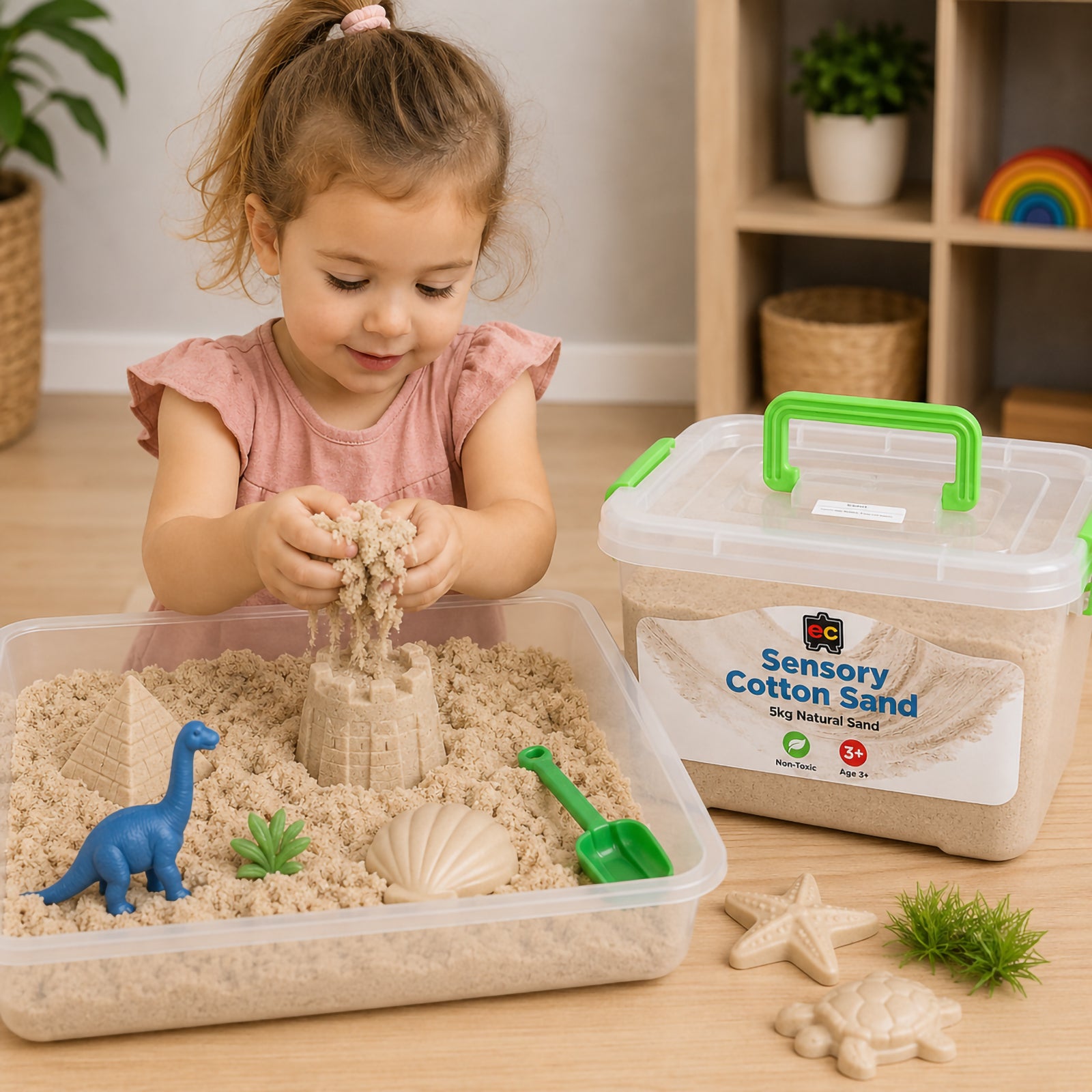 Child playing with natural coloured sensory cotton sand in a sensory tray using moulds and miniature figures beside a reusable 5kg storage container.
