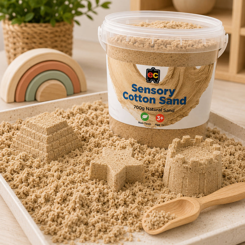 Natural coloured sensory cotton sand displayed in a tray with moulded castles, star shapes, and wooden scoop for tactile play activities.