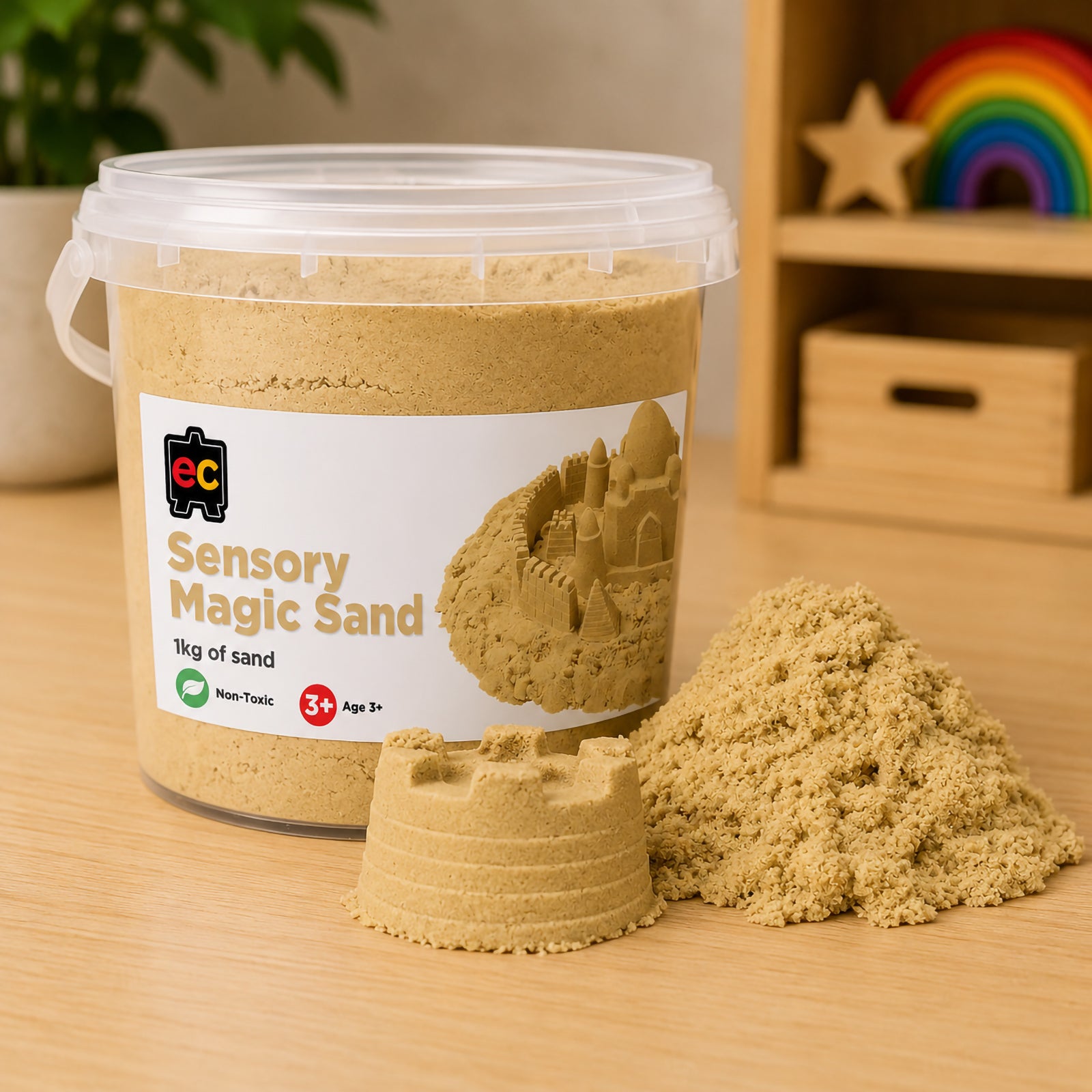 Educational Colours Sensory Magic Sand 1kg Natural displayed in large reusable container beside realistic sandcastle mould and pile of soft textured sensory sand on classroom table.