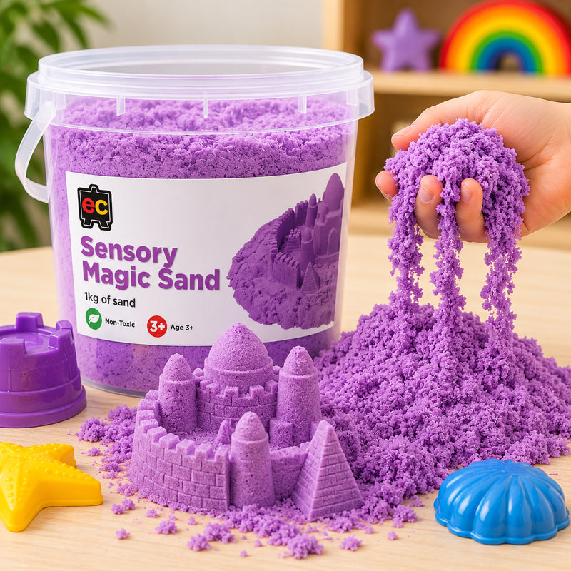 Close up of purple sensory magic sand flowing through a child’s hand with detailed sand castle models and colourful moulds nearby.