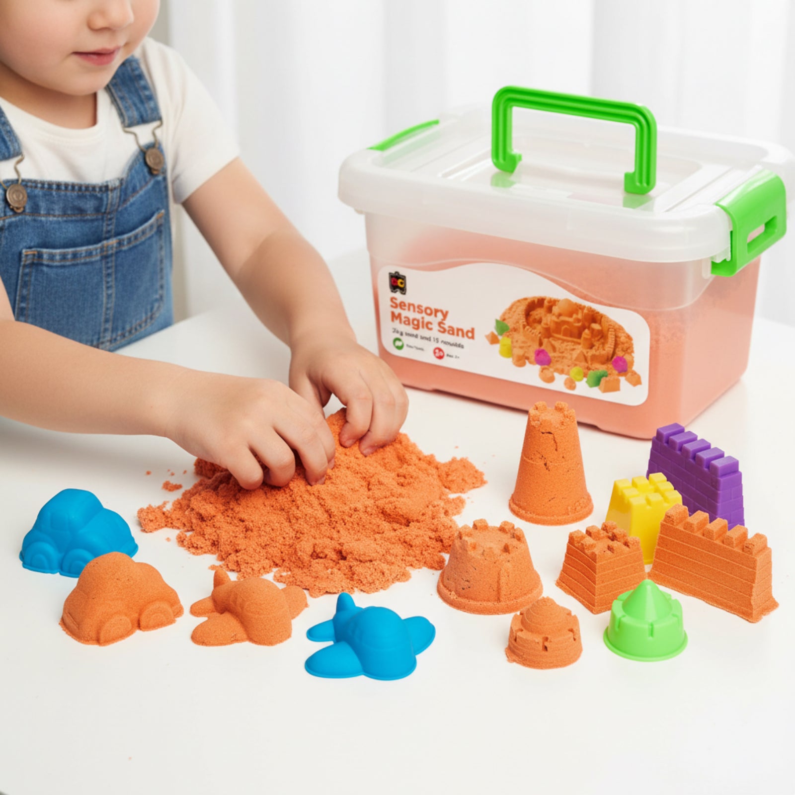 Child playing with Educational Colours Sensory Magic Sand with Moulds 2kg Orange while shaping soft orange sand beside colourful mould accessories and reusable storage container.