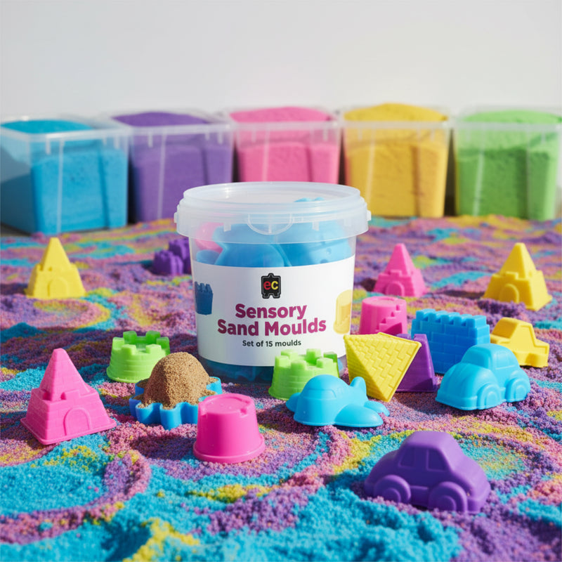 Assorted sensory sand moulds displayed across colourful textured sensory sand including castles, vehicles, pyramids, and creative shapes.