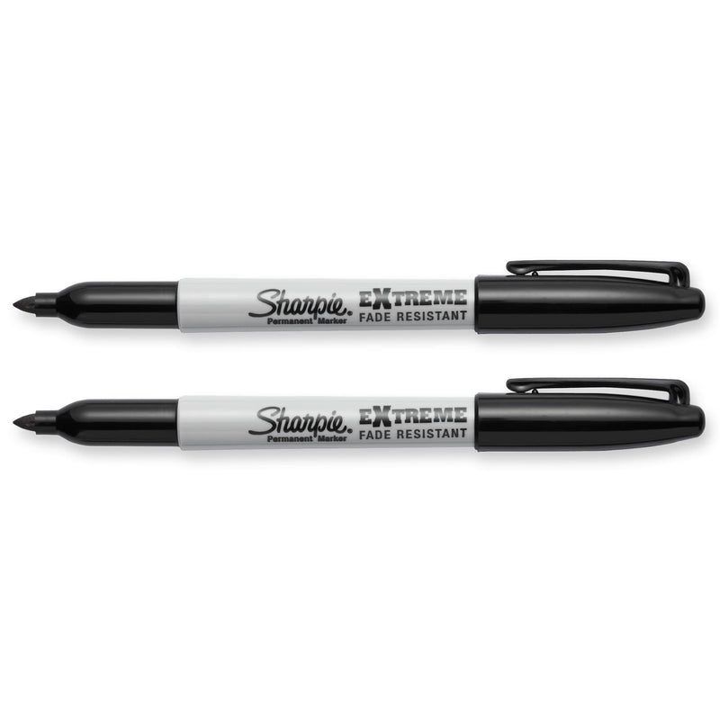 Two black Sharpie Extreme markers uncapped with caps posted, lying horizontally on a white background.