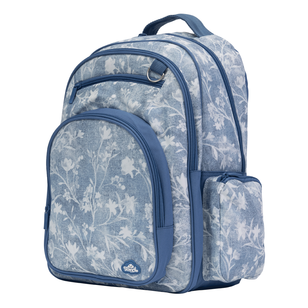 Spencil Denim Daze Big Kids Backpack, three-quarter view showing the side pocket, light denim-blue print with white flowers and navy trim