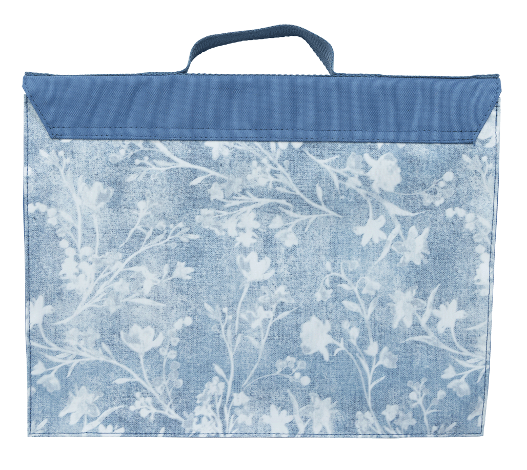 Back of the Spencil Denim Daze library bag with the denim floral print running across the panel beneath the plain fold-over flap and top handle